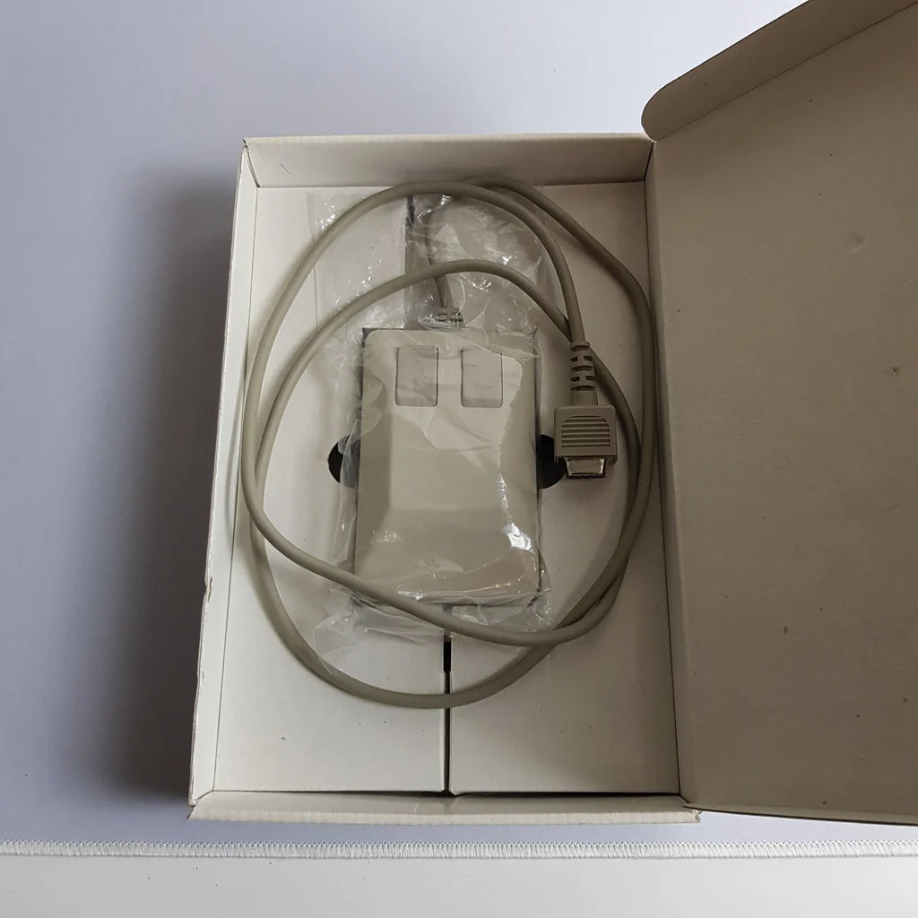 A doboz belseje, benne a Commodore 1351 egér műanyag zacskóban, kábellel és csatlakozóval.