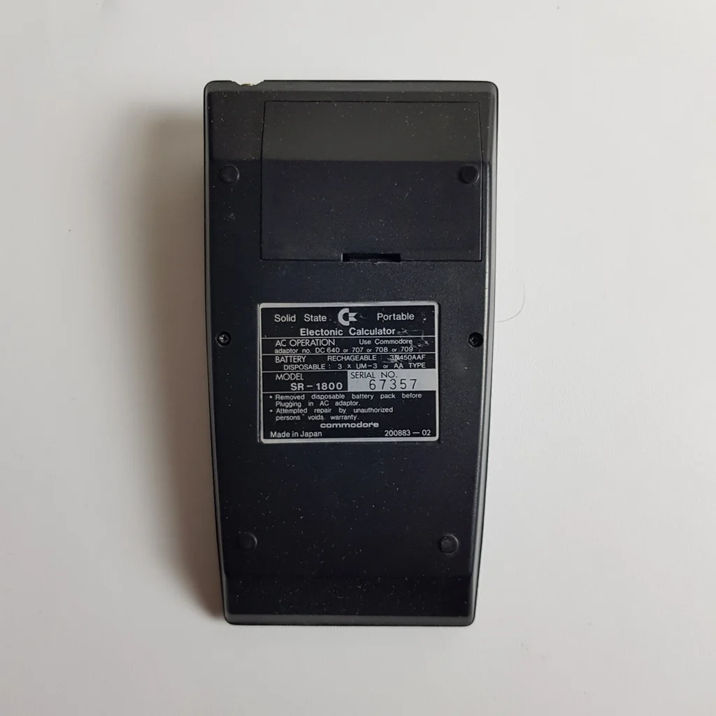 Commodore SR-1800 számológép hátulnézetből, címkével és sorozatszámmal.