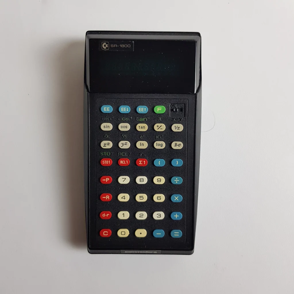 Commodore SR-1800 tudományos számológép elölnézetből, színes gombokkal.