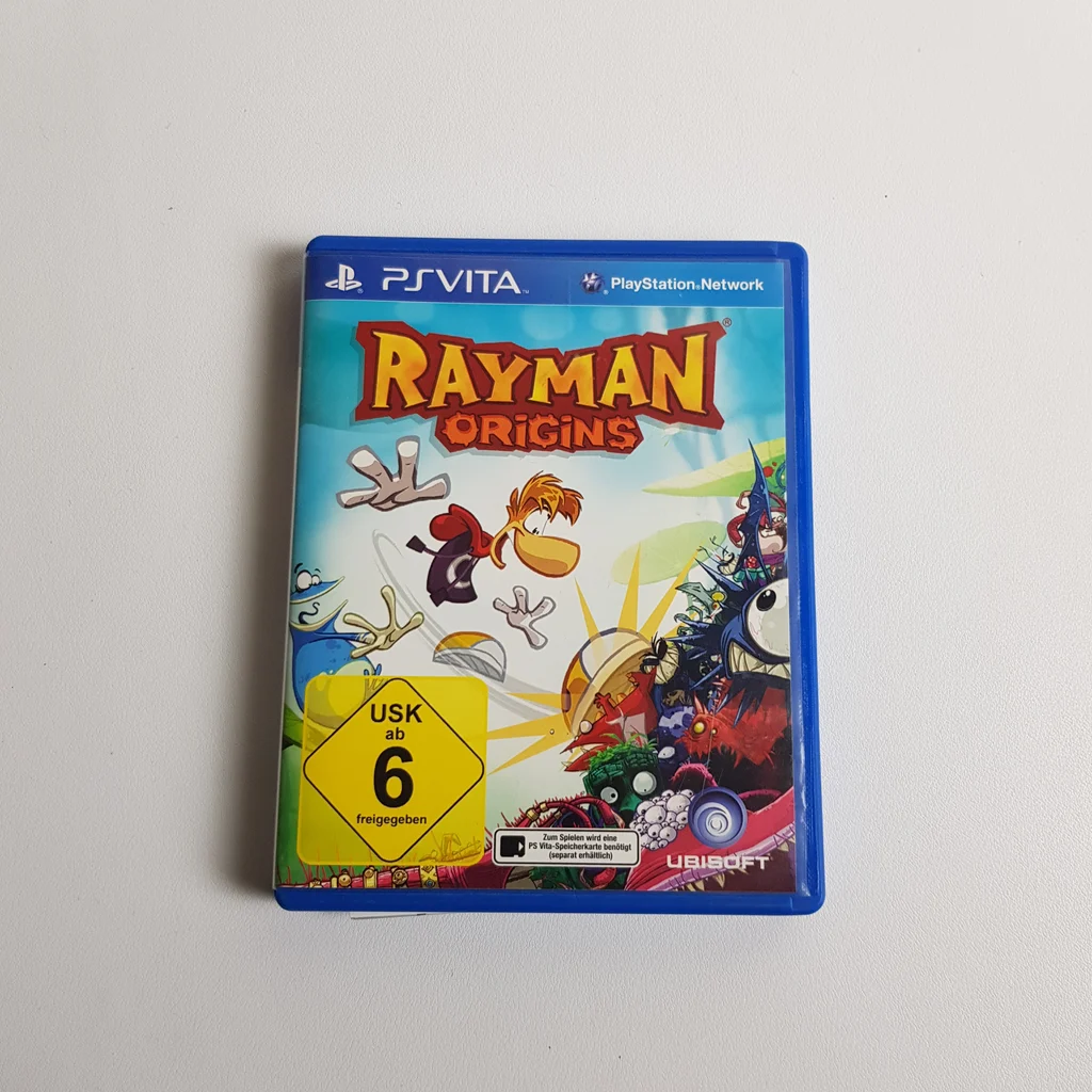 Rayman Origins PS Vita játék borítója Rayman Origins videojáték borítója PS Vita platformra, színes karakterekkel és logókkal.