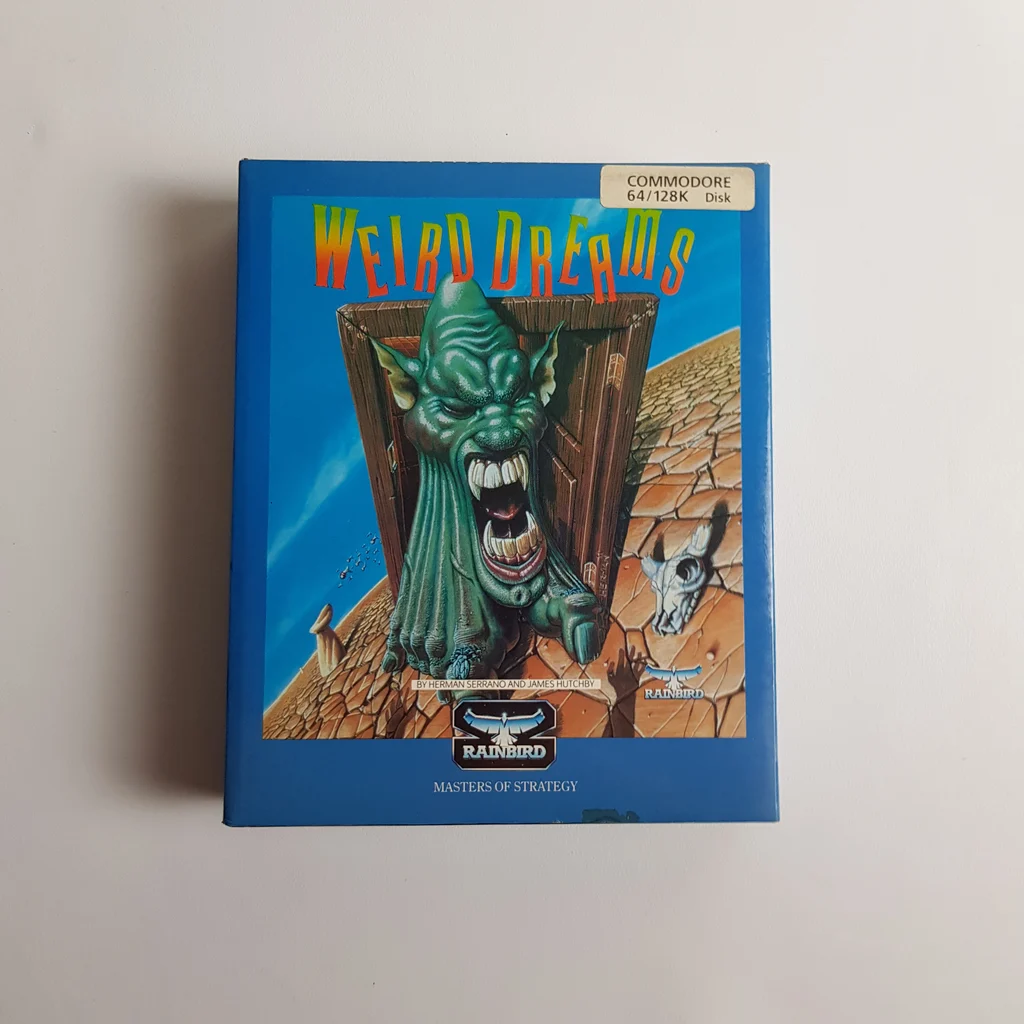Weird Dreams Commodore 64/128K videojáték doboz elölről Weird Dreams videojáték doboz elölnézete, színes borítóval és Commodore 64/128K felirattal